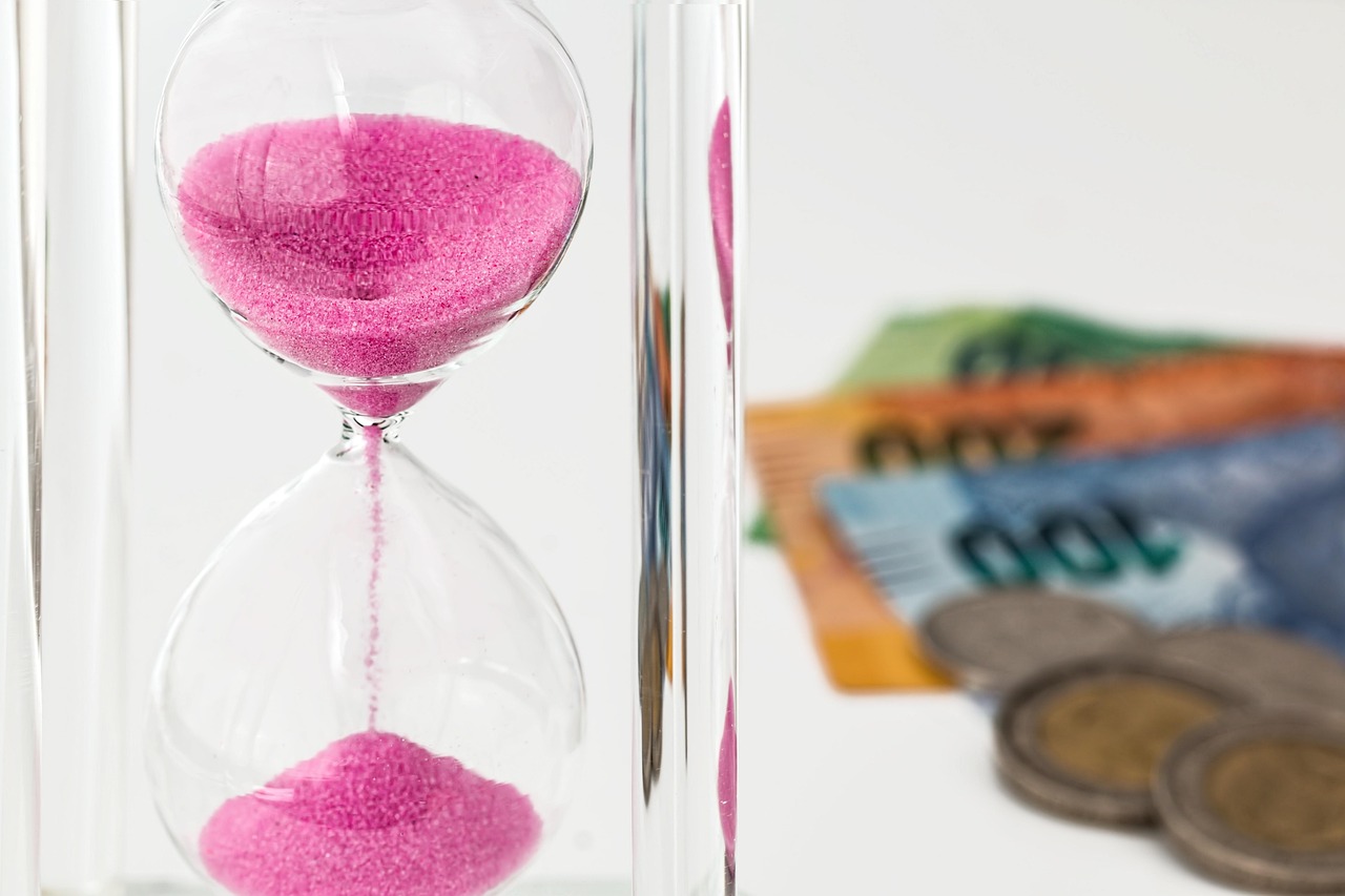 Hourglass, money, time — Financial Maestro: Stuart Piltch's Strategic Contributions to Fiscal Excellence